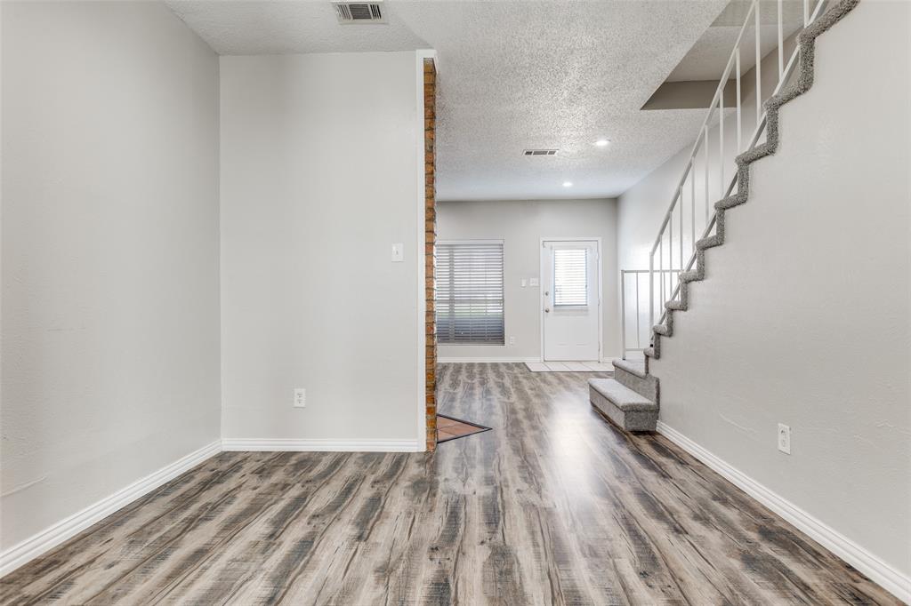 633 Carriagehouse Lane, Unit I6 Garland, TX 75040 - Photo 23 of 24 a view of entryway with wooden floor