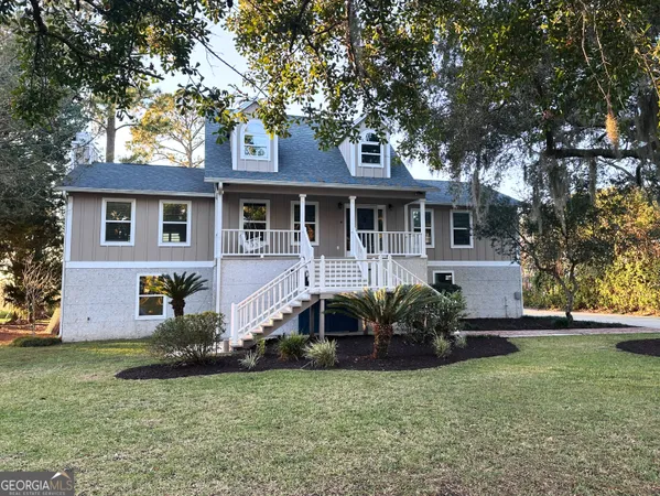 a front view of a house with a garden