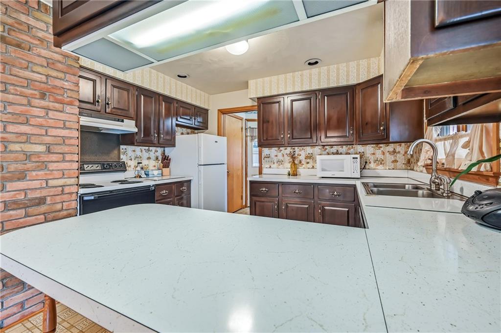2635 South Keel Ridge Road Hermitage, PA 16148 - Photo 11 of 49 a large kitchen with stainless steel appliances and a refrigerator