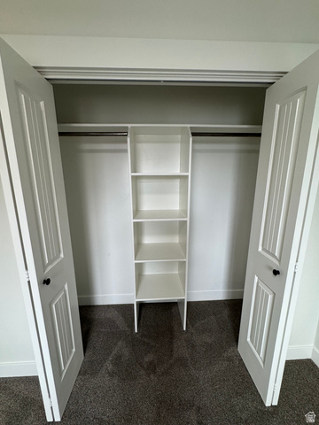 608 South 500 West, Unit 3 Provo, UT 84601 - Photo 32 of 35 Closet featuring dual bifold doors, built-in shelving, hanging rods, and dark gray carpeting
