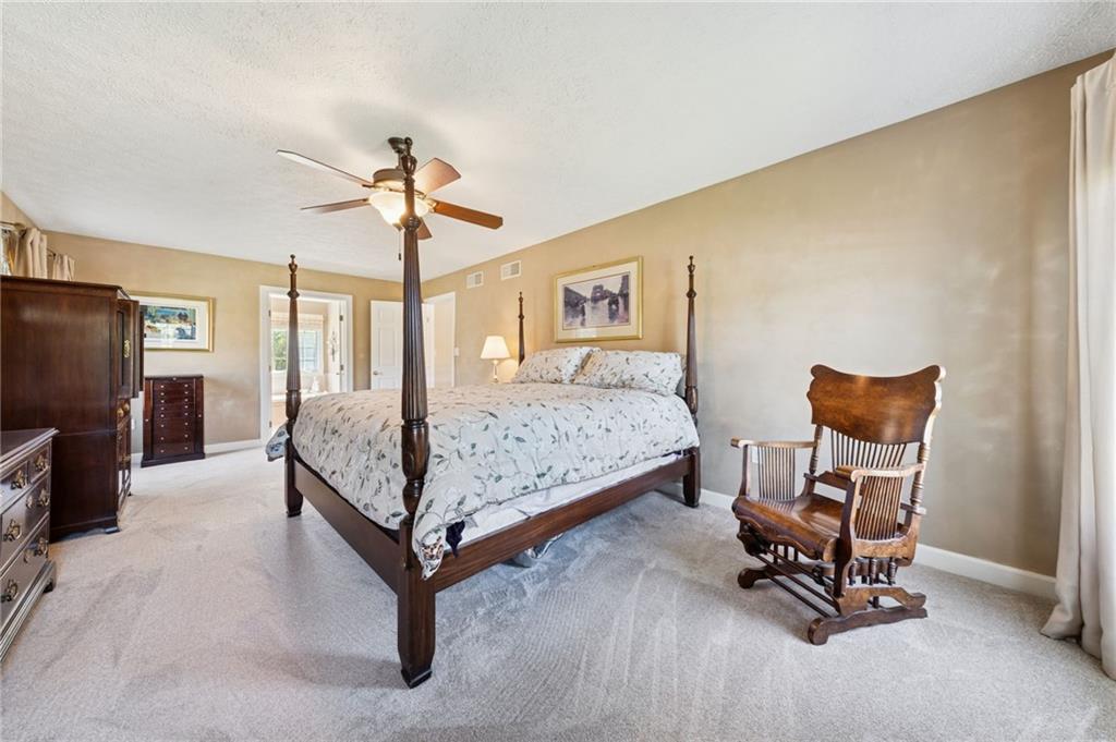 188 Meadow Spring Road Greensburg, PA 15601 - Photo 19 of 43 a bedroom with a bed and a chandelier