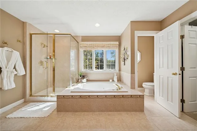 a living room with large window and a chandelier