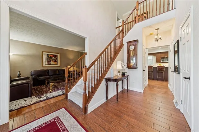 a view of entryway and hall with wooden floor