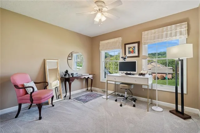a view of a livingroom with workspace and a window