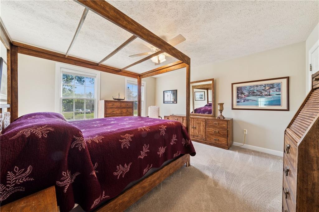 188 Meadow Spring Road Greensburg, PA 15601 - Photo 23 of 43 a bedroom with a large bed and a chandelier