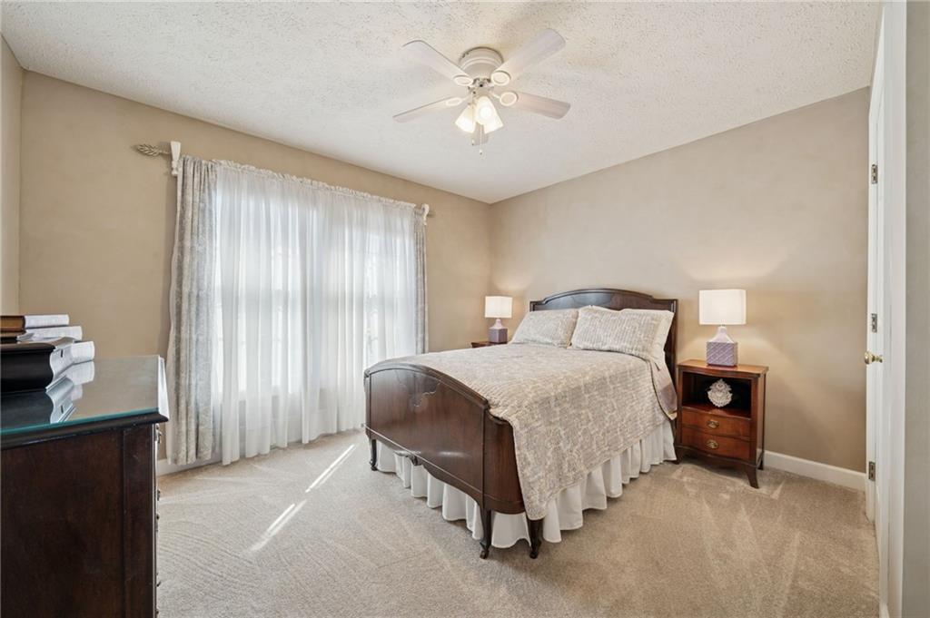 188 Meadow Spring Road Greensburg, PA 15601 - Photo 26 of 43 a bedroom with a bed and a chandelier