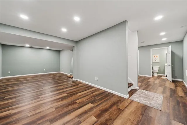 a view of a room with wooden floor and bedroom