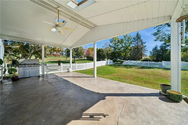 a view of a house with backyard and sitting area