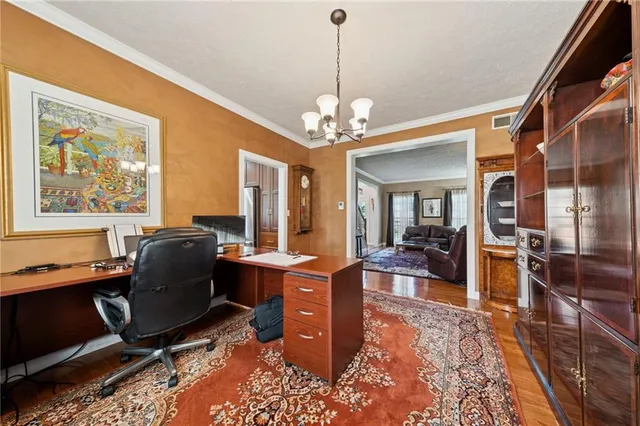 a living room with furniture a chandelier and a table