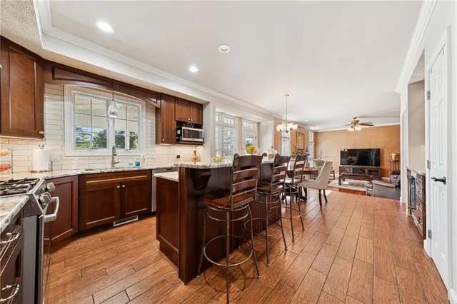 a kitchen with lots of counter top space and wooden floor