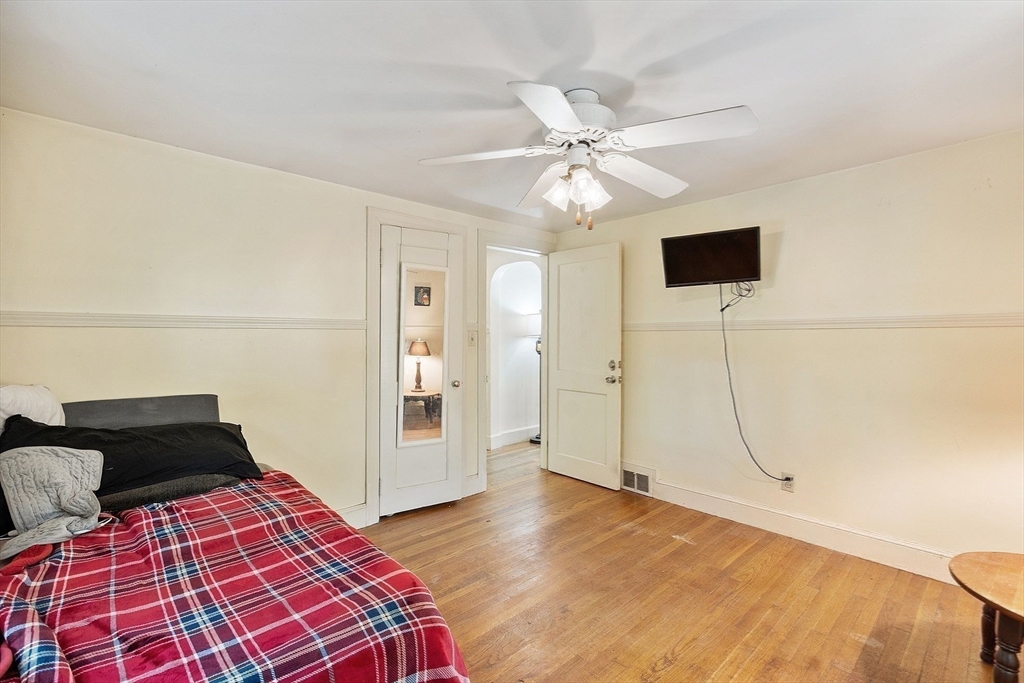 29 Warwick Road Gardner, MA 01440 - Photo 20 of 31 a bedroom with a bed and a chandelier