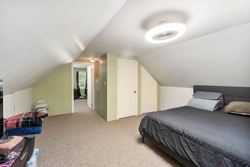 29 Warwick Road Gardner, MA 01440 - Photo 25 of 31 a bedroom with a bed and a chandelier