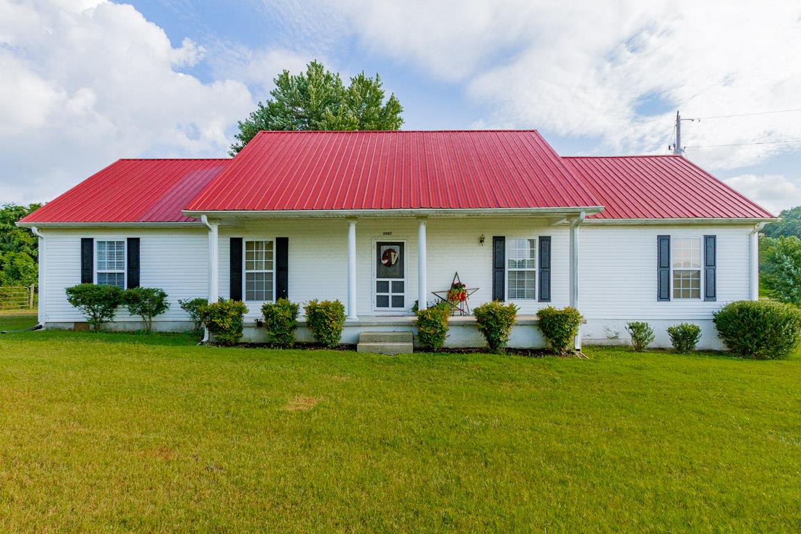 a view of a house with a yard porch and sitting area