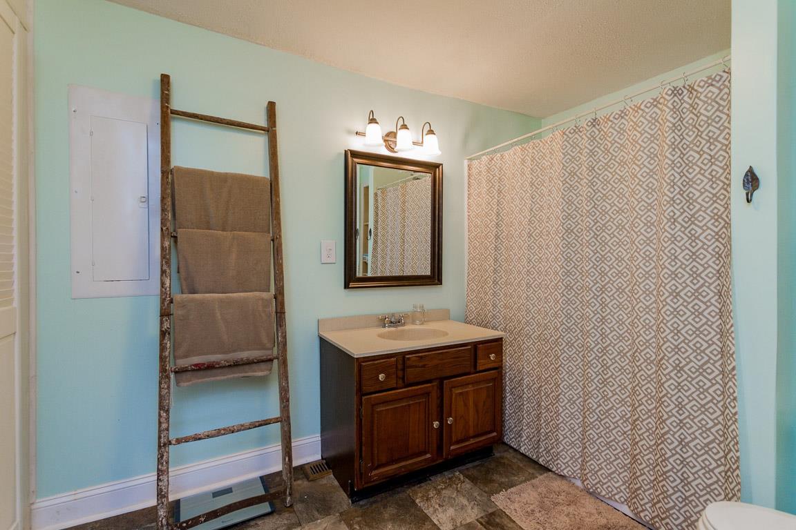 3507 Anderson Road Cedar Hill, TN 37032 - Photo 13 of 30 a bathroom with a sink a mirror and cabinets