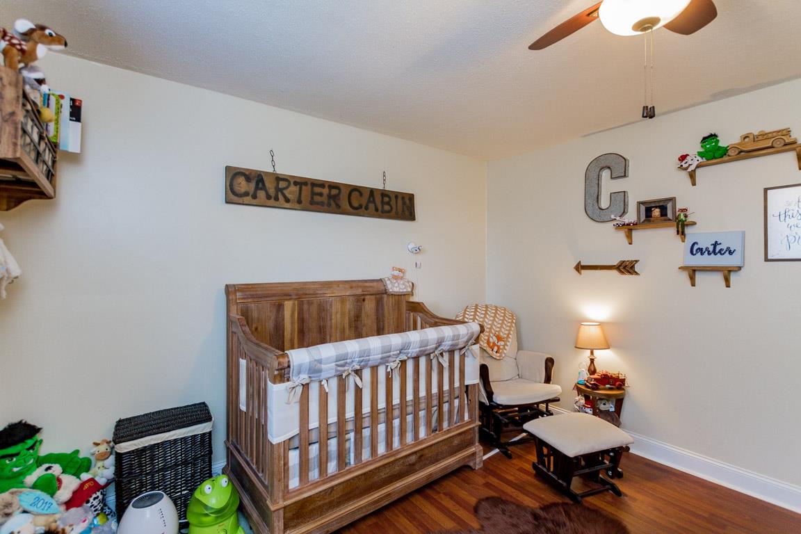 3507 Anderson Road Cedar Hill, TN 37032 - Photo 20 of 30 a bedroom with a bed and wooden floor