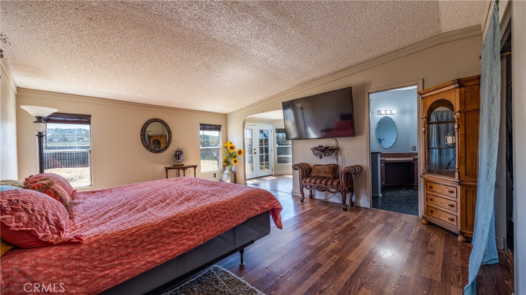 39550 Kirby Road Anza, CA 92539 - Photo 17 of 53 a bedroom with a bed and wooden floor