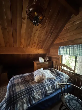 a view of a backyard with wooden floor and fence