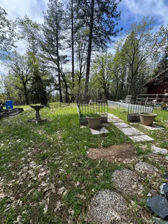 a backyard of a house with yard and trampoline