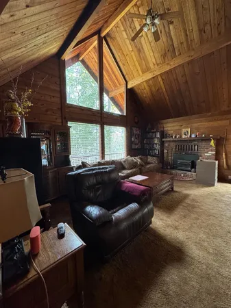 a living room with furniture a fireplace and a large window