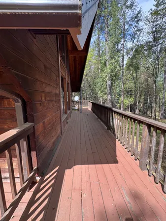 a view of balcony with wooden floor and fence