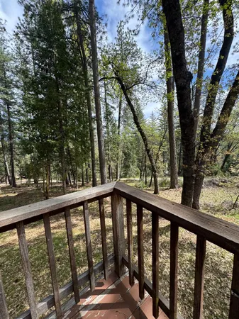 a balcony with trees in front of it