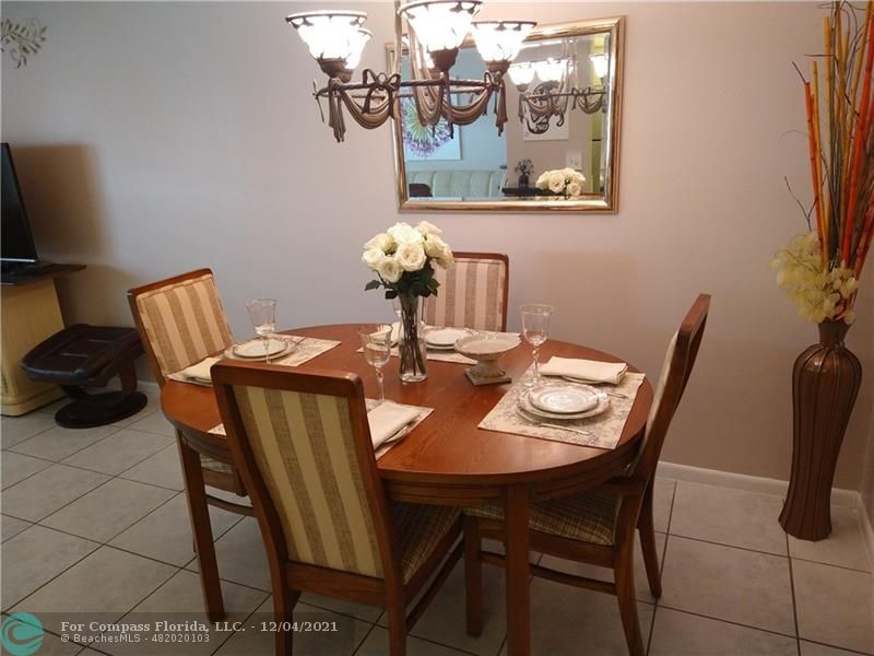 287 Markham M, Unit 287 Deerfield Beach, FL 33442 - Photo 15 of 64 a dining room with furniture and wooden floor