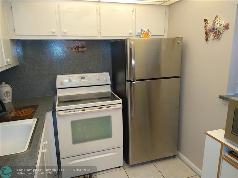 287 Markham M, Unit 287 Deerfield Beach, FL 33442 - Photo 19 of 64 a white refrigerator freezer sitting inside of a kitchen