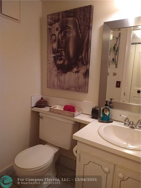 287 Markham M, Unit 287 Deerfield Beach, FL 33442 - Photo 32 of 64 a bathroom with a toilet sink and mirror