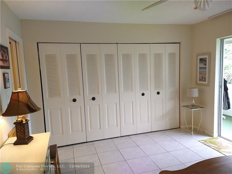 287 Markham M, Unit 287 Deerfield Beach, FL 33442 - Photo 41 of 64 a view of a livingroom with wooden floor and cabinet