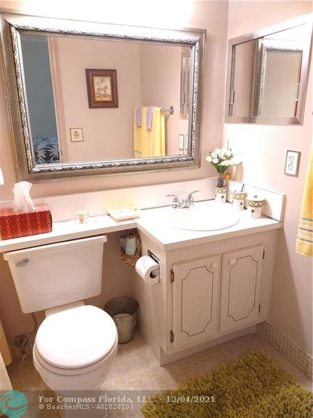 287 Markham M, Unit 287 Deerfield Beach, FL 33442 - Photo 42 of 64 a bathroom with a toilet sink and mirror