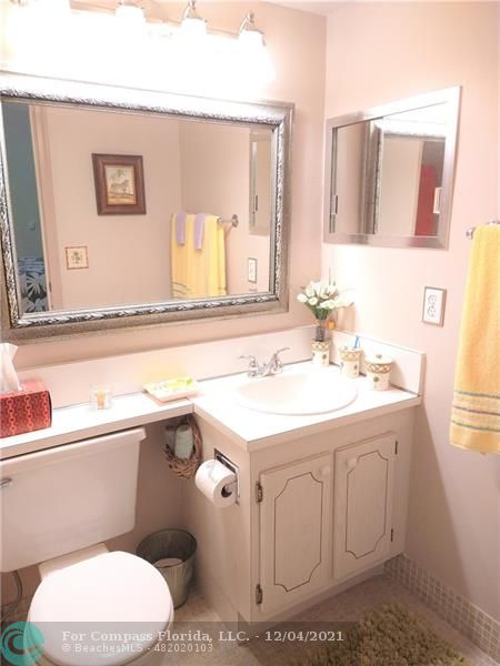 287 Markham M, Unit 287 Deerfield Beach, FL 33442 - Photo 43 of 64 a bathroom with a sink a toilet and mirror