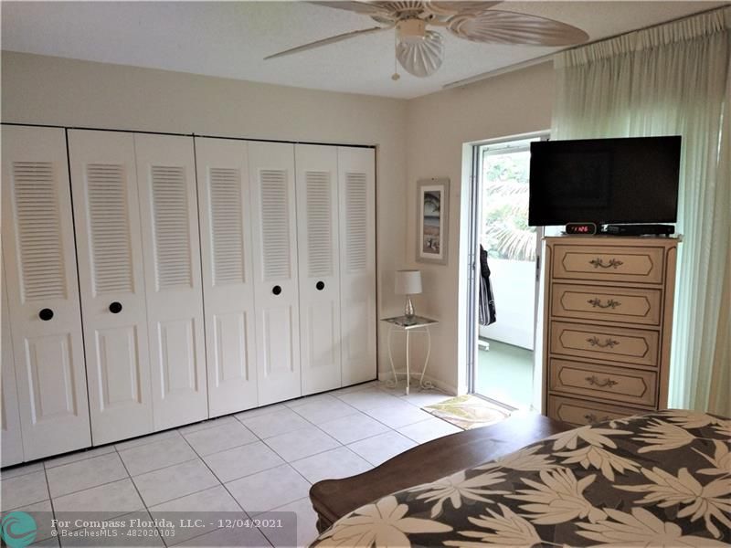 287 Markham M, Unit 287 Deerfield Beach, FL 33442 - Photo 49 of 64 a bedroom with a bed and flat screen tv