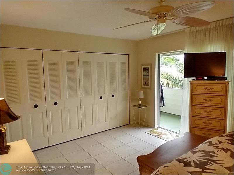 287 Markham M, Unit 287 Deerfield Beach, FL 33442 - Photo 52 of 64 a bedroom with a bed and a flat screen tv