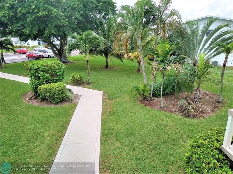 287 Markham M, Unit 287 Deerfield Beach, FL 33442 - Photo 63 of 64 a view of yard with swimming pool and green space