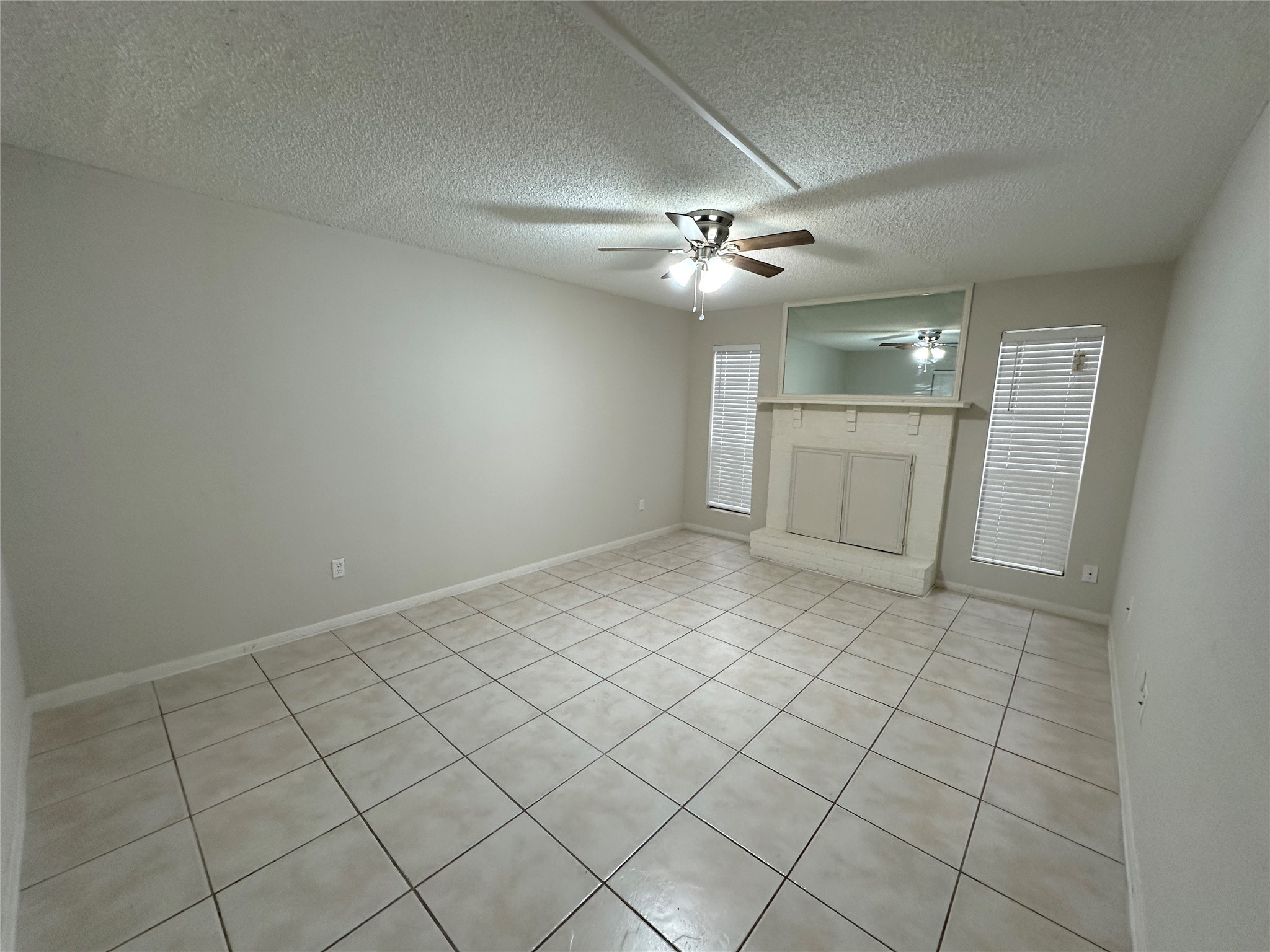 1500 Bay Area Boulevard, Unit 155 Houston, TX 77058 - Photo 5 of 16 an empty room with windows and fan