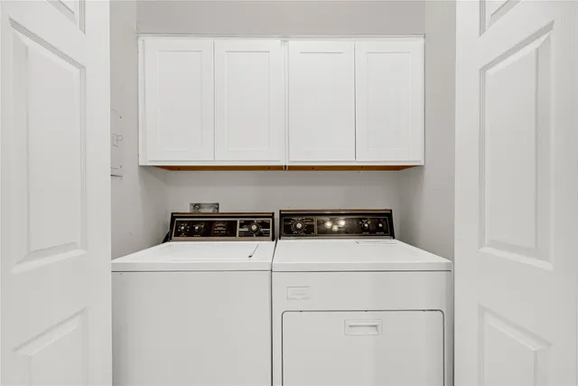 a close view of washer and dryer with wooden floor