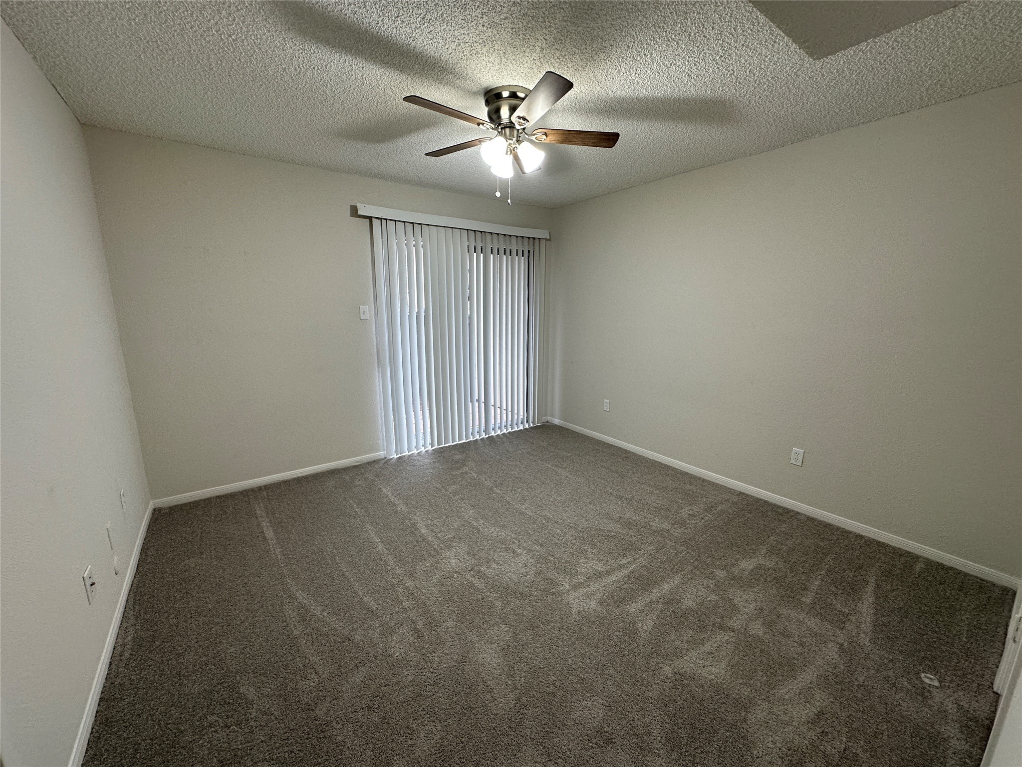 1500 Bay Area Boulevard, Unit 155 Houston, TX 77058 - Photo 10 of 16 an empty room with a chandelier fan and windows