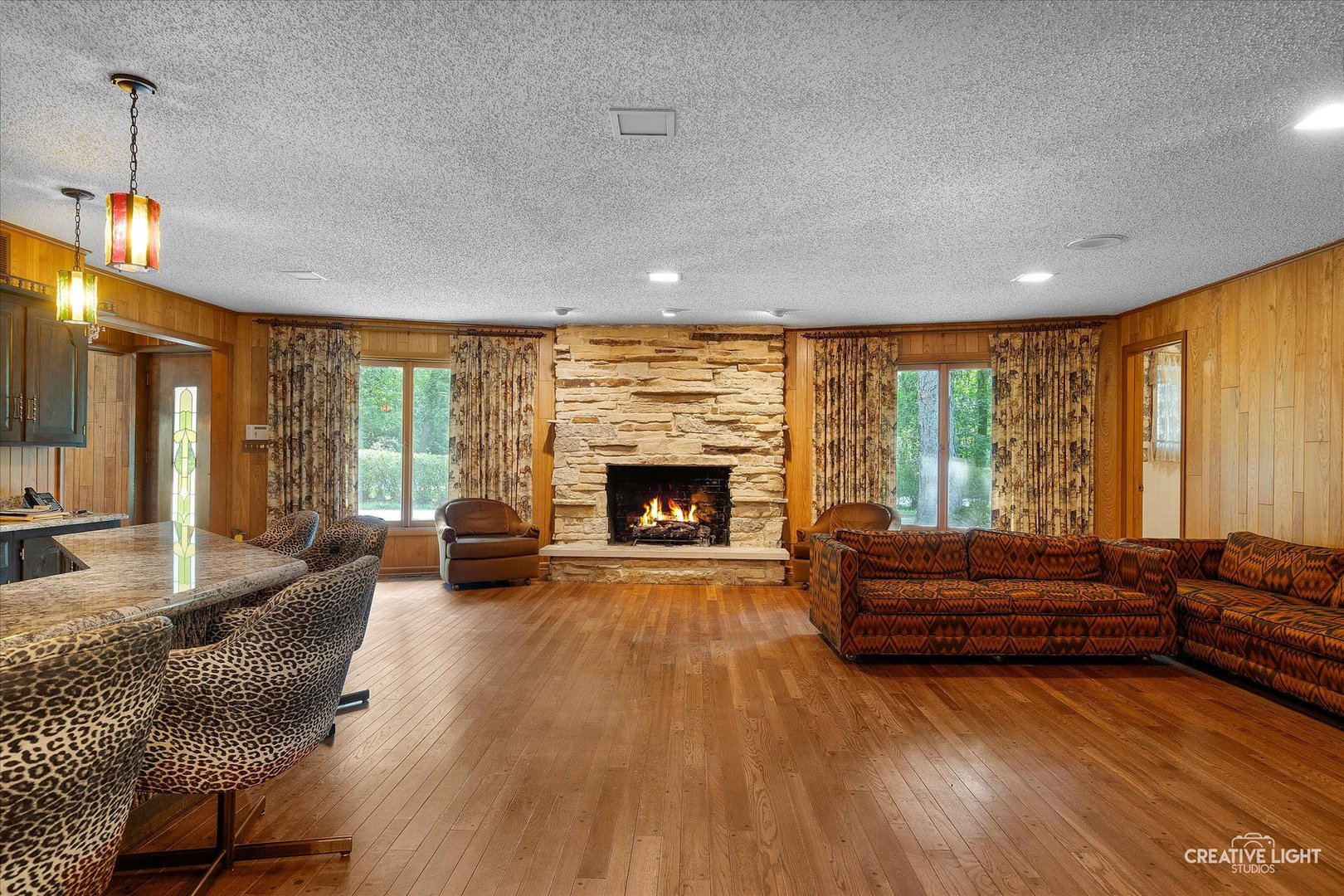 16323 Griswold Springs Road Plano, IL 60545 - Photo 9 of 55 a living room with furniture fireplace and large windows