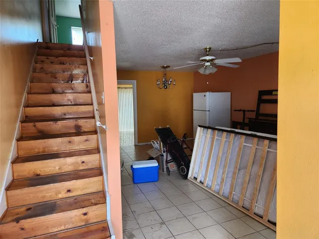 a view of a hallway with entryway front door wooden floor and windows