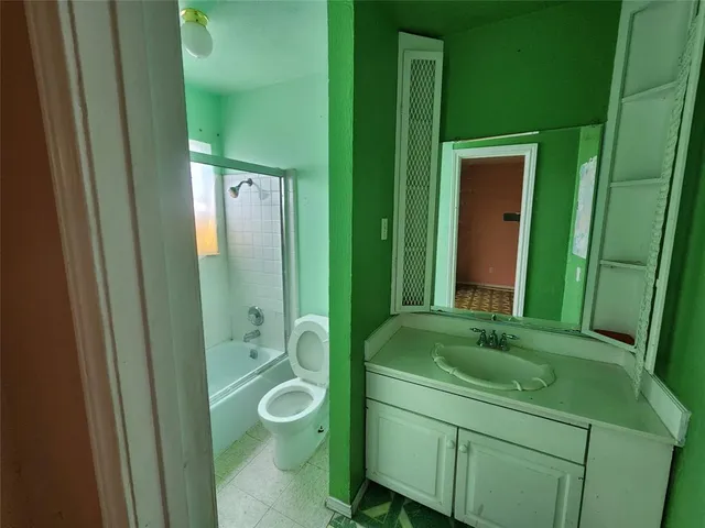 a bathroom with a shower a sink and mirror