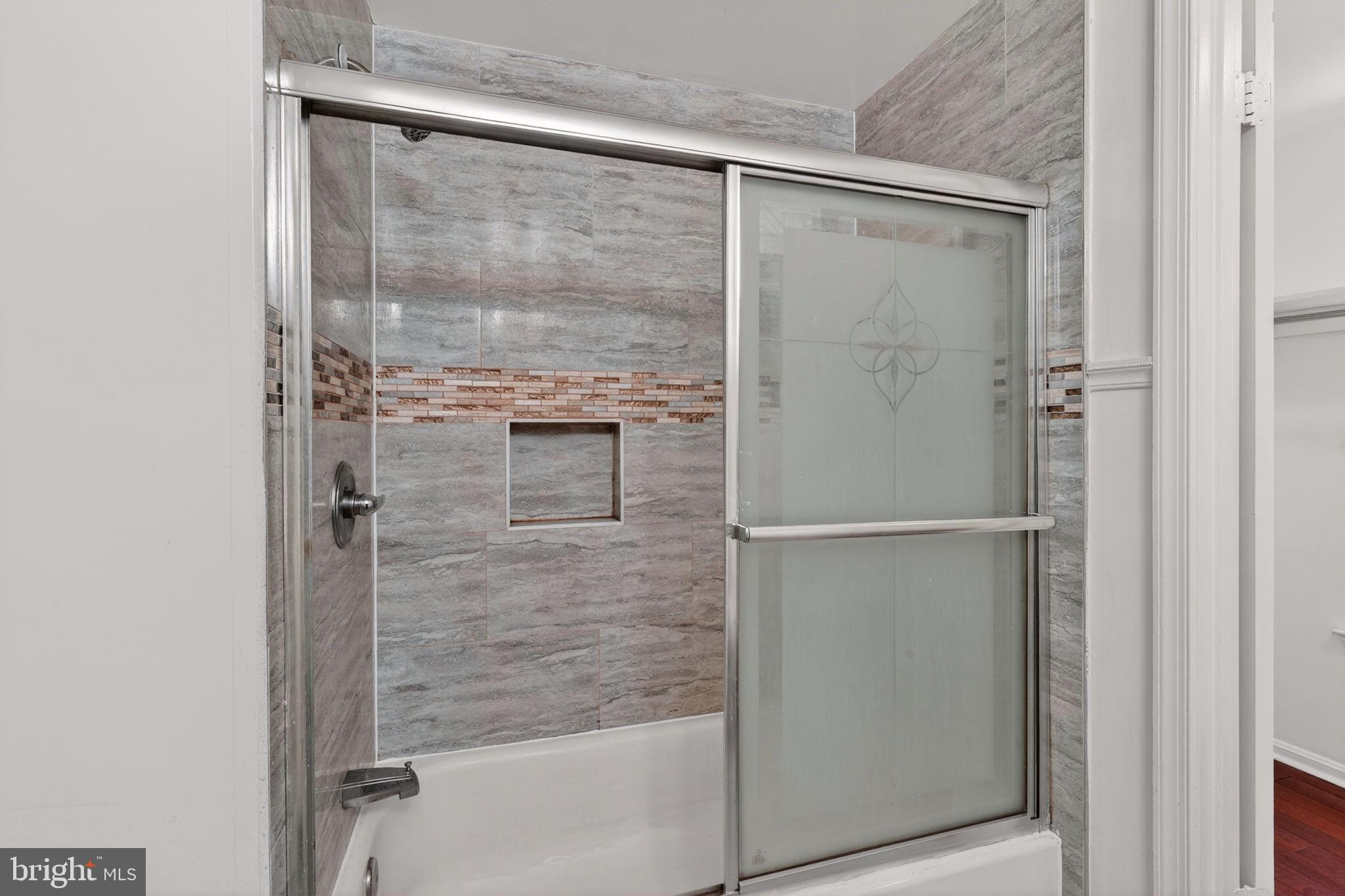 12447 Loft Lane Silver Spring, MD 20904 - Photo 26 of 45 Sleek modern shower with elegant tiles.