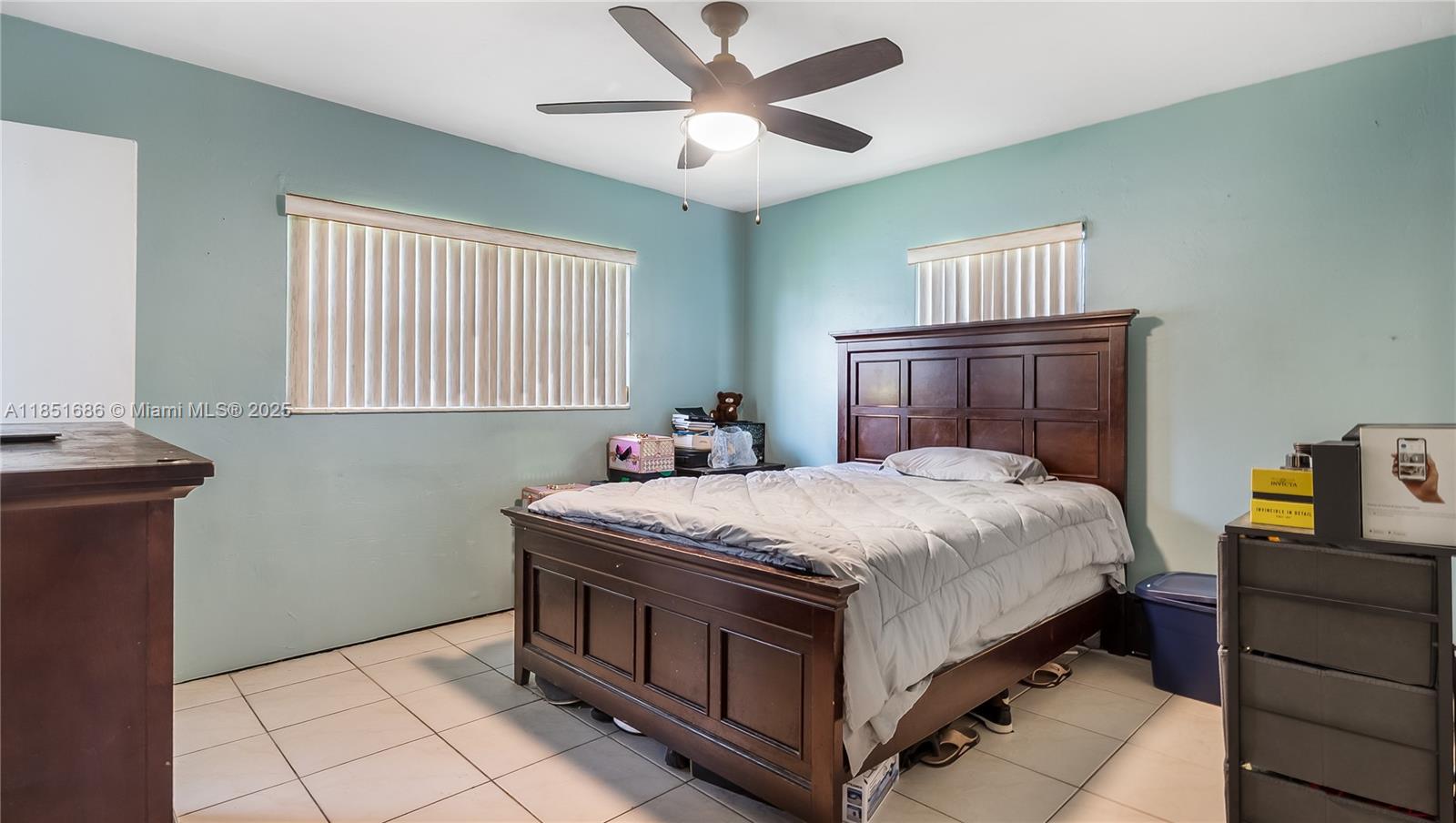 6528 Southwest 26th Street Miramar, FL 33023 - Photo 14 of 29 a bedroom with a bed and a chandelier