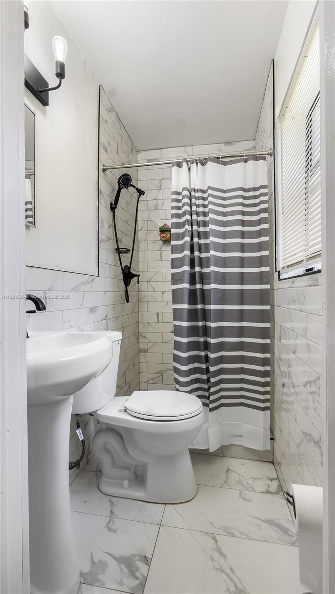 6528 Southwest 26th Street Miramar, FL 33023 - Photo 17 of 29 a bathroom with a sink toilet and shower