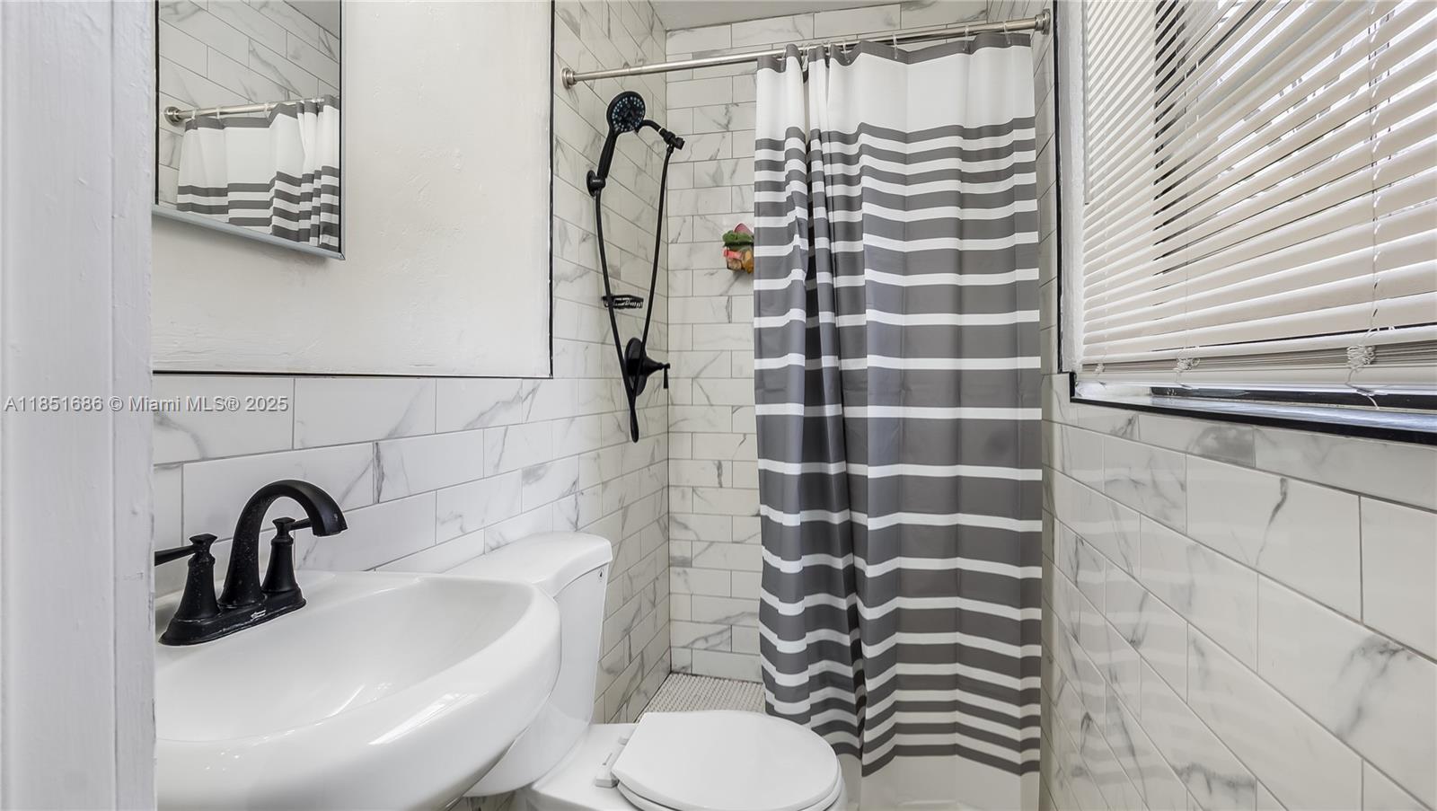 6528 Southwest 26th Street Miramar, FL 33023 - Photo 18 of 29 a bathroom with a sink toilet and shower