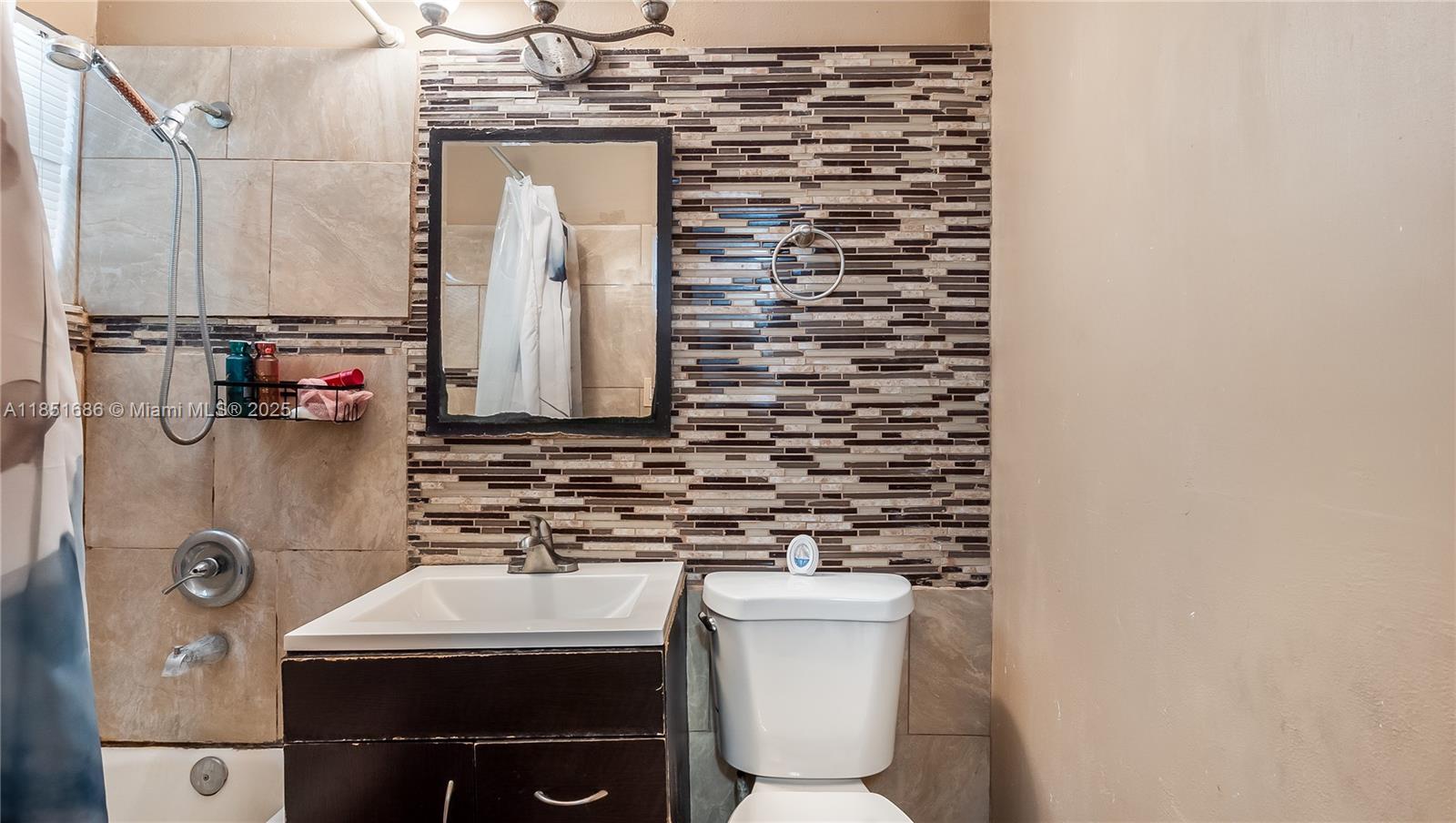 6528 Southwest 26th Street Miramar, FL 33023 - Photo 22 of 29 a bathroom with a toilet sink and mirror