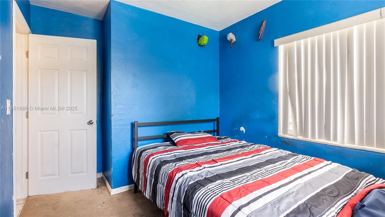 6528 Southwest 26th Street Miramar, FL 33023 - Photo 24 of 29 a bedroom with a bed and a window