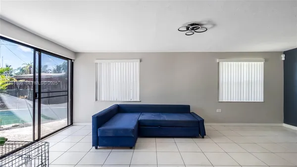 a living room with a couch and a shower