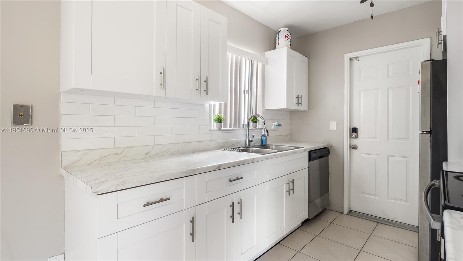 6528 Southwest 26th Street Miramar, FL 33023 - Photo 8 of 29 a kitchen with white cabinets and sink