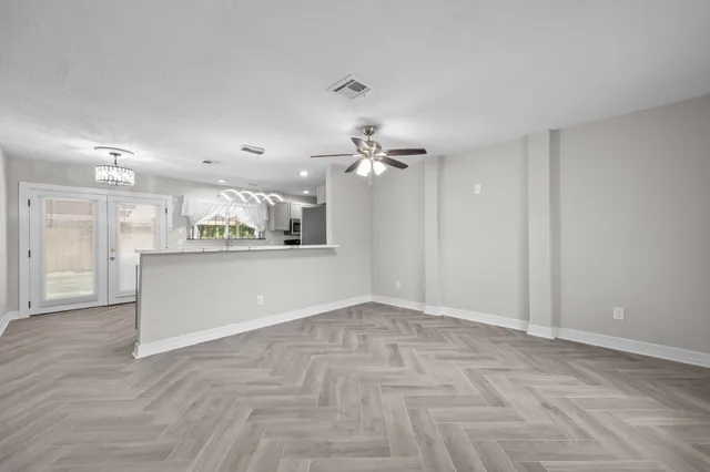 a view of a kitchen with a sink and a refrigerator
