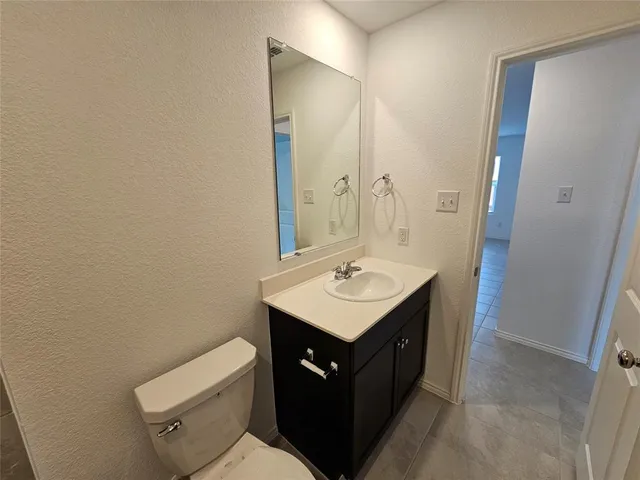 a bathroom with a sink toilet and mirror